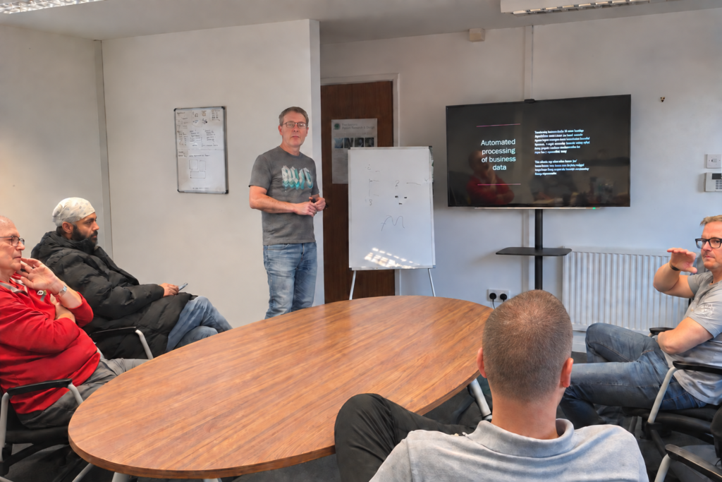 An AI training session with attendees sat around a table at Chestnut House, Chorley